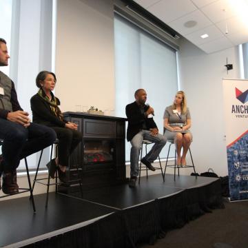 Panel members in front of fireplace